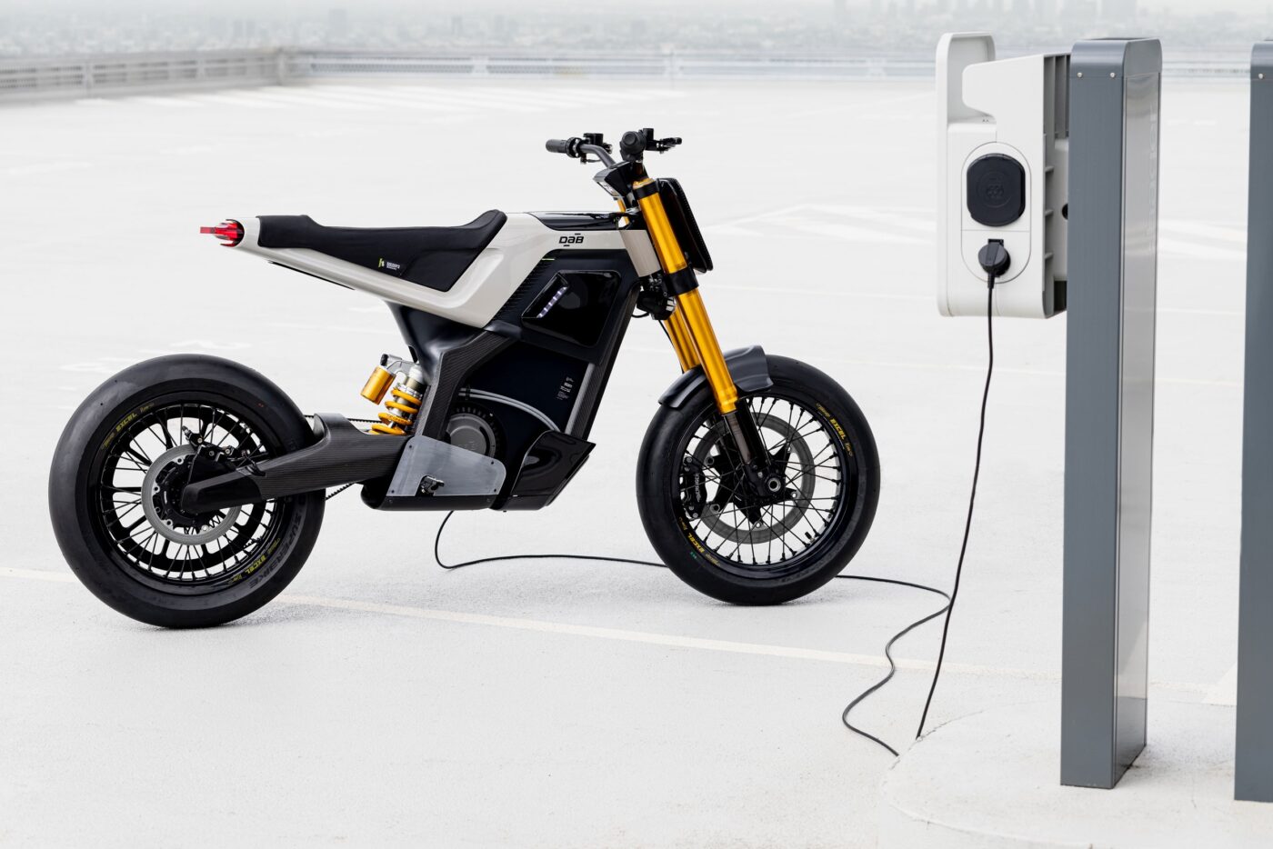 Concept-E electric motorcycle by Pierrick Pichaureaux Electric bike plugged into an outlet on a stand.